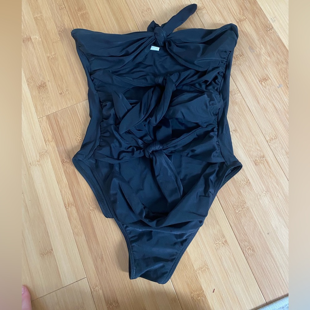 Black one piece mono kini with ties/bows.